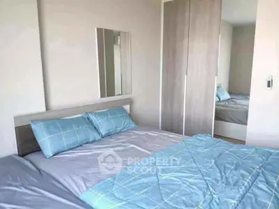 Cozy bedroom with modern wardrobe and stylish bedding in a bright apartment.