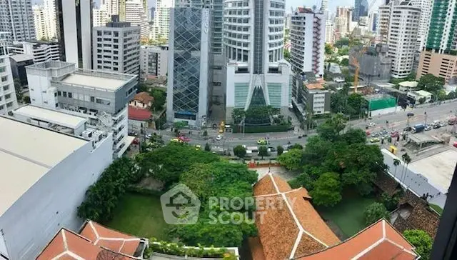 Stunning cityscape view showcasing modern skyscrapers and lush greenery from a high vantage point.