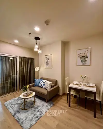 Cozy living room with modern decor and dining area, perfect for urban living.