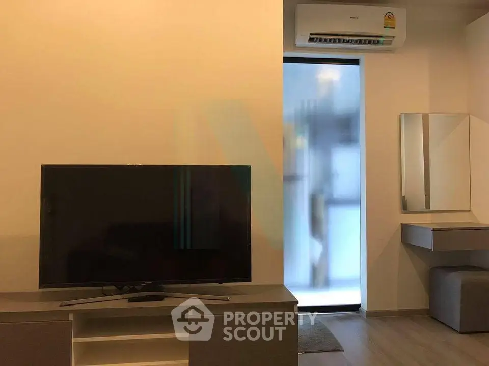 Modern living room with sleek TV unit and air conditioning, perfect for cozy entertainment.