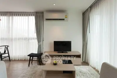 Modern living room with sleek furniture and large windows for natural light