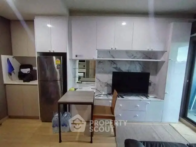 Modern kitchen with sleek cabinetry and integrated appliances in a stylish apartment.