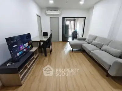 Modern living room with sleek furniture and entertainment setup in a stylish apartment.
