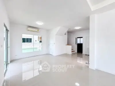 Spacious modern living room with glossy tile flooring and ample natural light