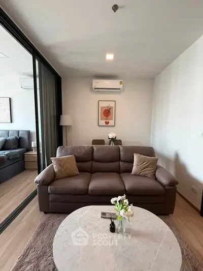 Modern living room with cozy leather sofa and stylish decor in a contemporary apartment.