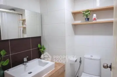 Modern bathroom with sleek sink and stylish shelving, perfect for contemporary living.