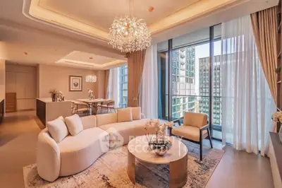 Luxurious modern living room with elegant chandelier and floor-to-ceiling windows offering stunning city views.