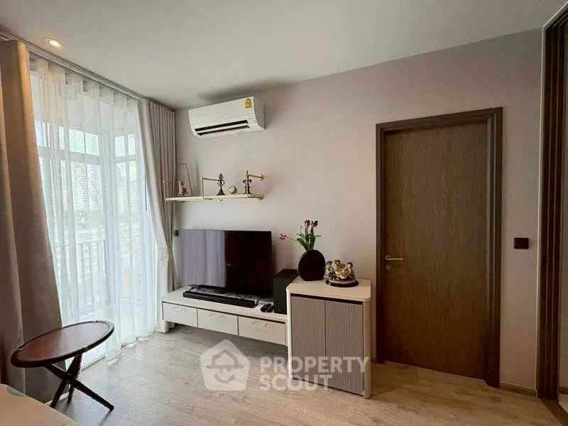 Modern living room with TV, air conditioning, and stylish decor
