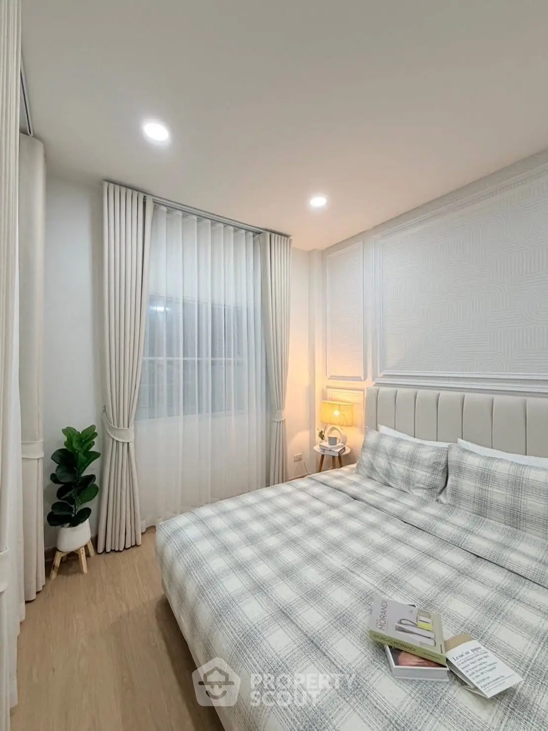 Cozy modern bedroom with stylish decor and natural light