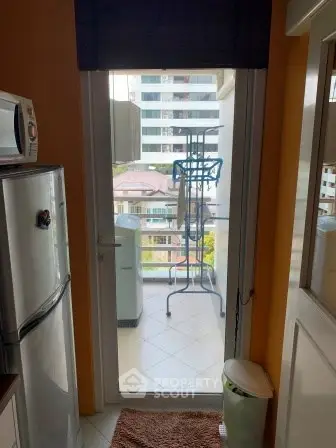 Compact kitchen with balcony view in modern apartment