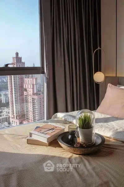 Luxurious bedroom with stunning city view, elegant decor, and cozy ambiance in high-rise apartment.