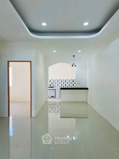 Modern open layout kitchen with sleek design and glossy floor tiles