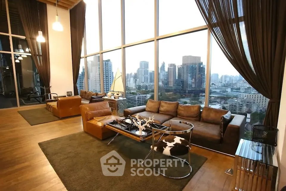 Luxurious high-rise living room with stunning city skyline view and elegant decor.