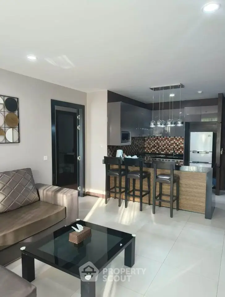 Modern open-layout living room with stylish kitchen and elegant decor