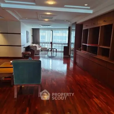 Spacious living room with polished wooden floors and elegant furnishings