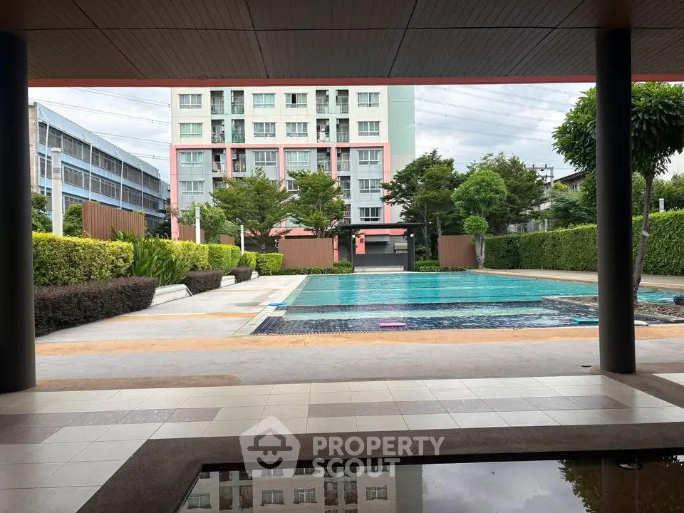 Modern apartment complex with inviting outdoor pool and lush greenery