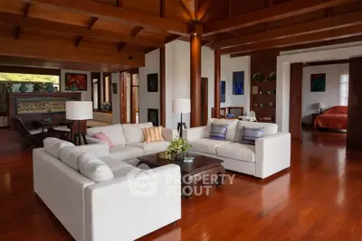 Luxurious open-plan living room with elegant wooden flooring and stylish decor