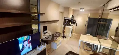 Modern apartment interior with open layout, featuring a cozy living area and compact kitchen.