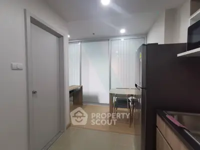 Modern kitchen with dining area and sleek appliances in a stylish apartment