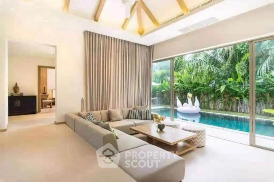 Luxurious living room with pool view and modern decor