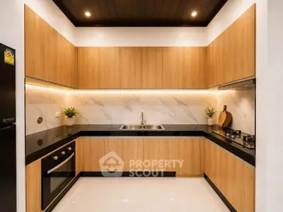 Modern kitchen with sleek wooden cabinets and built-in appliances