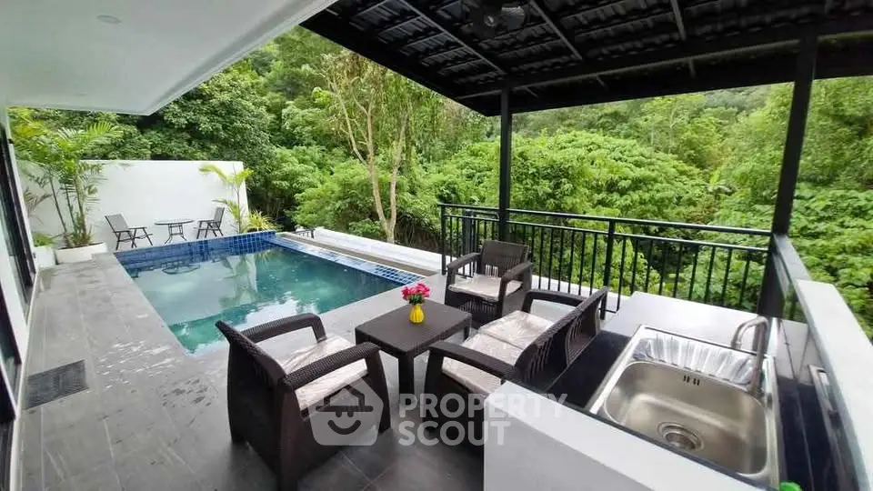 Luxurious outdoor pool area with lush greenery and stylish seating, perfect for relaxation and entertaining.