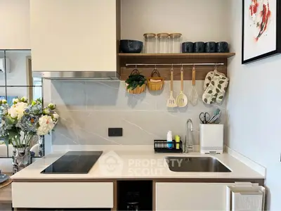 Modern kitchen with sleek design, featuring induction cooktop and stylish shelving.