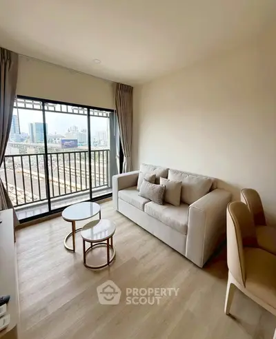 Modern living room with city view, featuring stylish sofa and elegant coffee tables.