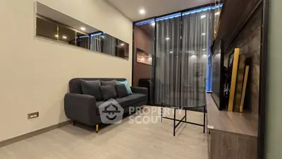 Modern living room with sleek design, featuring a comfortable sofa and stylish decor, perfect for relaxation.