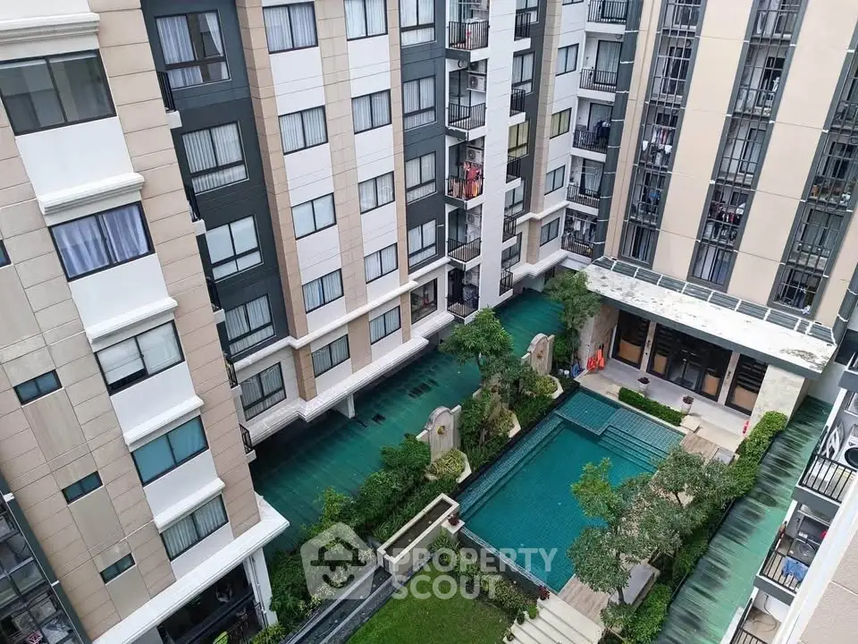 Modern apartment complex with pool and garden view from above