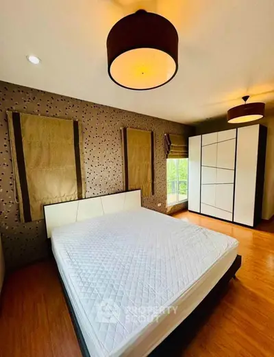 Spacious bedroom with modern decor and ample natural light