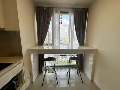 Modern kitchen with high table and city view, perfect for urban living.