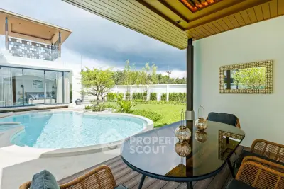 Luxurious modern villa with private pool and stylish outdoor seating area, perfect for relaxation and entertainment.
