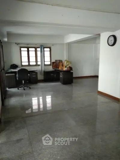 Spacious home office area with desk and chair, ideal for productivity.