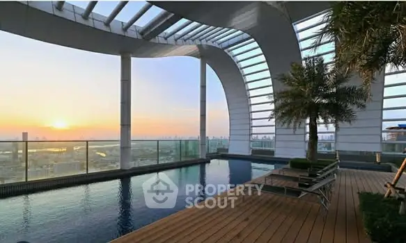Luxurious rooftop pool with stunning city skyline views at sunset.