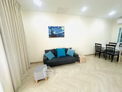 Modern living room with stylish furniture and elegant dining area