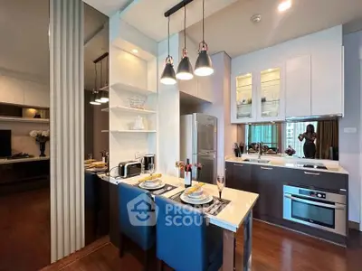 Modern kitchen with sleek design, featuring built-in oven, stylish lighting, and dining area in luxury apartment.