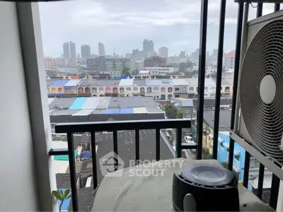 Urban balcony view with city skyline and air conditioning unit, perfect for city living enthusiasts.