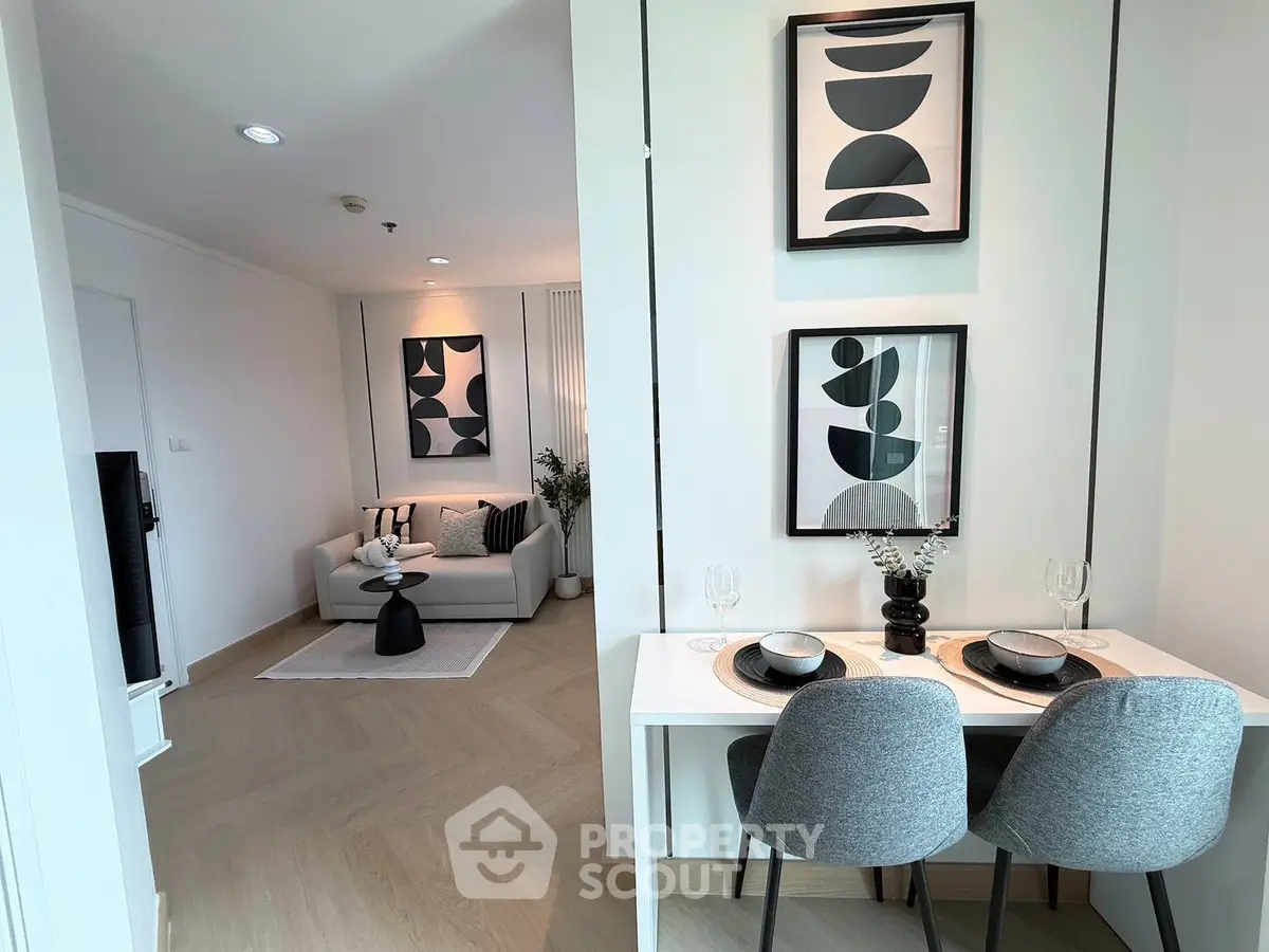 Modern living room with stylish decor and cozy dining area in open layout apartment.