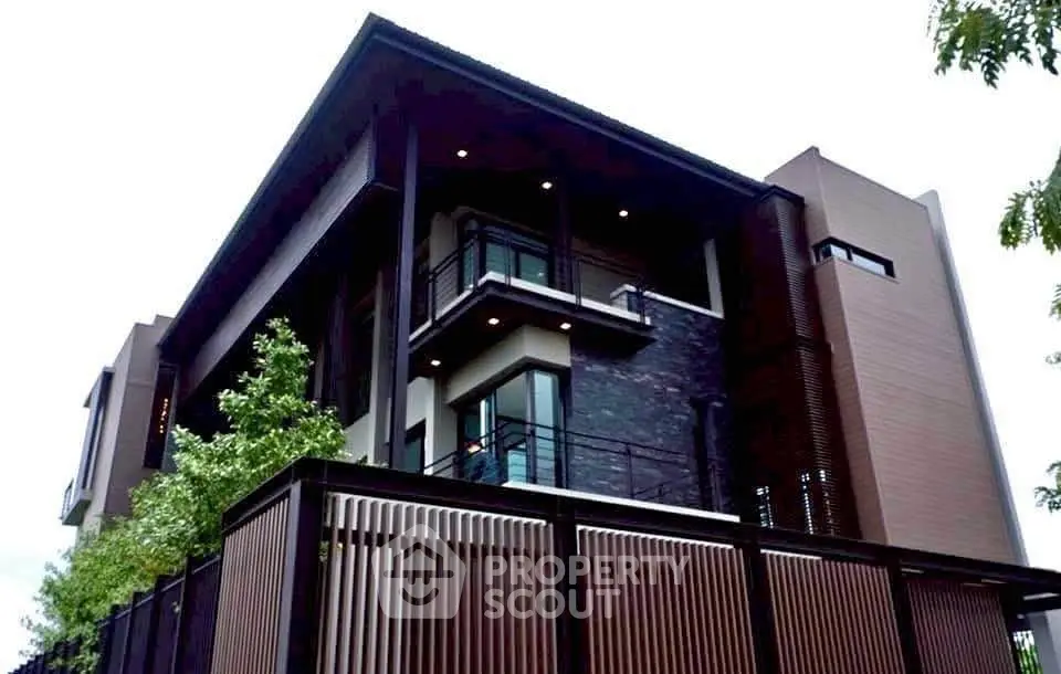Modern luxury home with sleek design and spacious balcony in upscale neighborhood.