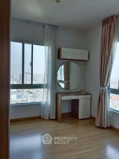 Spacious bedroom with city view and elegant vanity setup