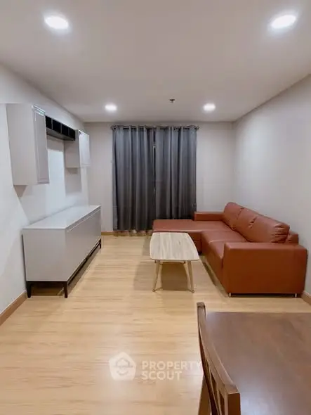 Modern living room with stylish furniture and wooden flooring, perfect for cozy gatherings.