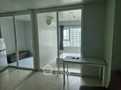 Modern condo interior with glass partition and city view