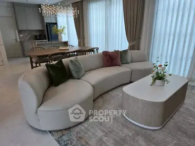 Luxurious modern living room with elegant curved sofa and chic dining area