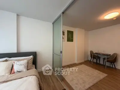 Modern studio apartment with sliding partition and cozy dining area
