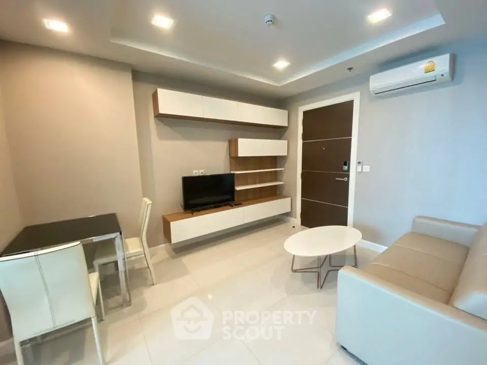 Modern living room with sleek furniture and air conditioning in a stylish apartment.