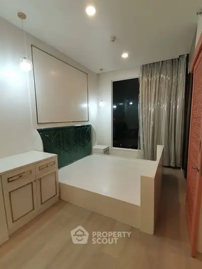 Modern bedroom with built-in bed and elegant lighting, featuring floor-to-ceiling window and stylish decor.