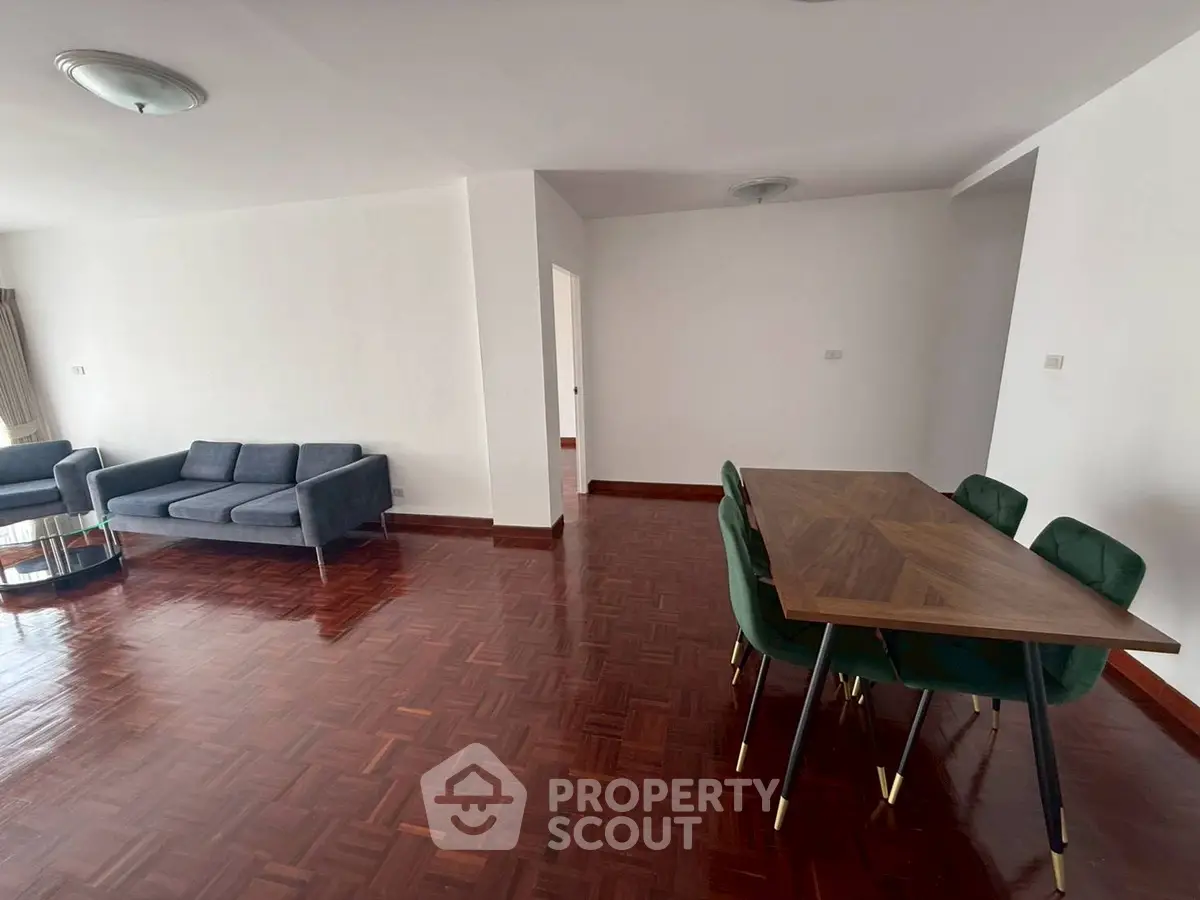 Spacious living room with elegant parquet flooring and modern furniture