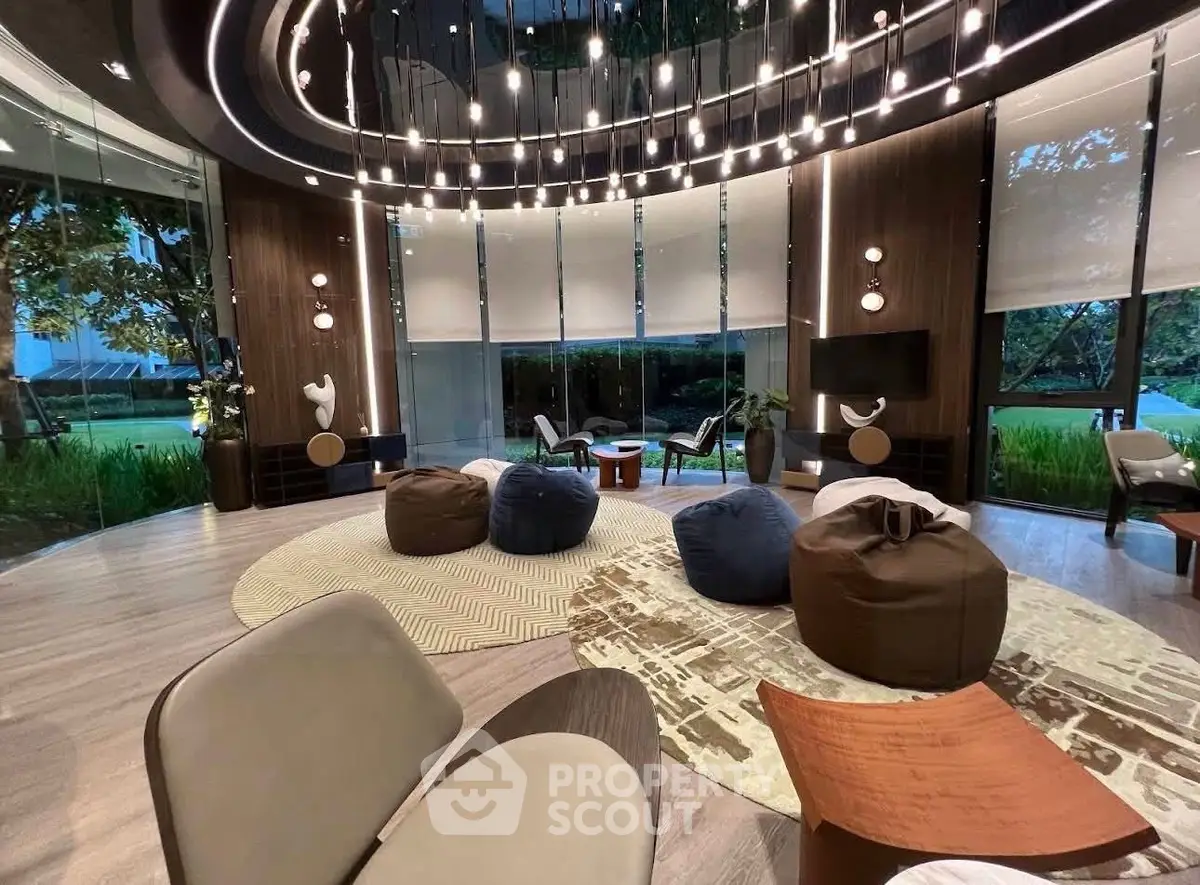 Luxurious modern living room with stylish seating and floor-to-ceiling windows offering serene garden views.