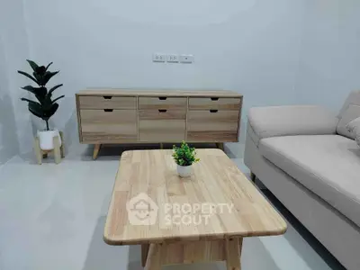 Modern living room with wooden furniture and neutral tones